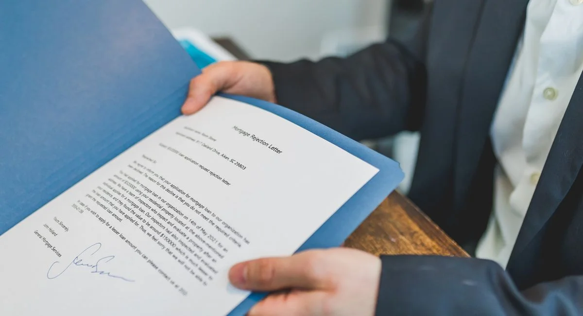 Closeup of a real estate contract being reviewed by an agent and client.