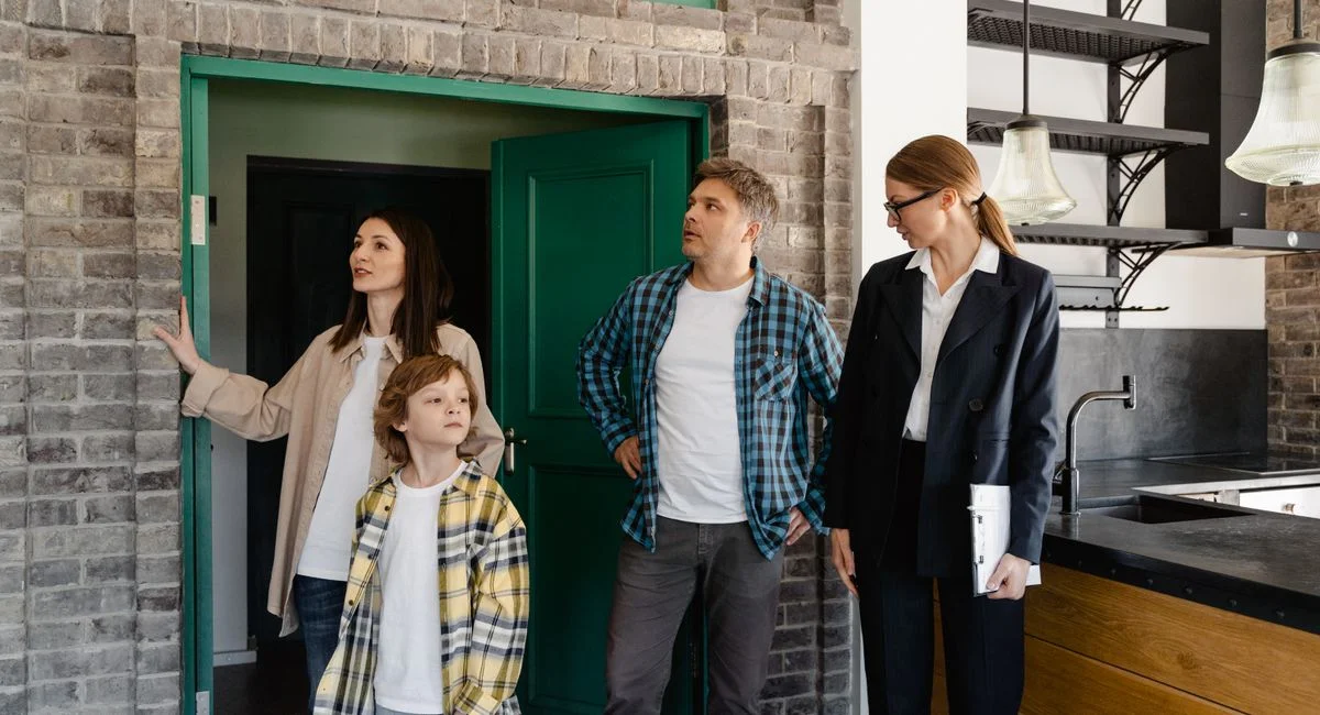 Family exploring potential new home guided by a real estate agent.