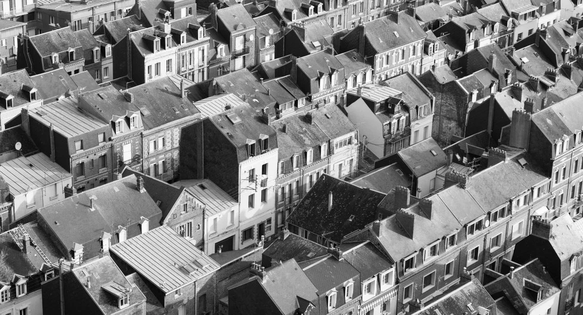 Black and white aerial photo of rooftops in Le Tréport, Normandy, France.