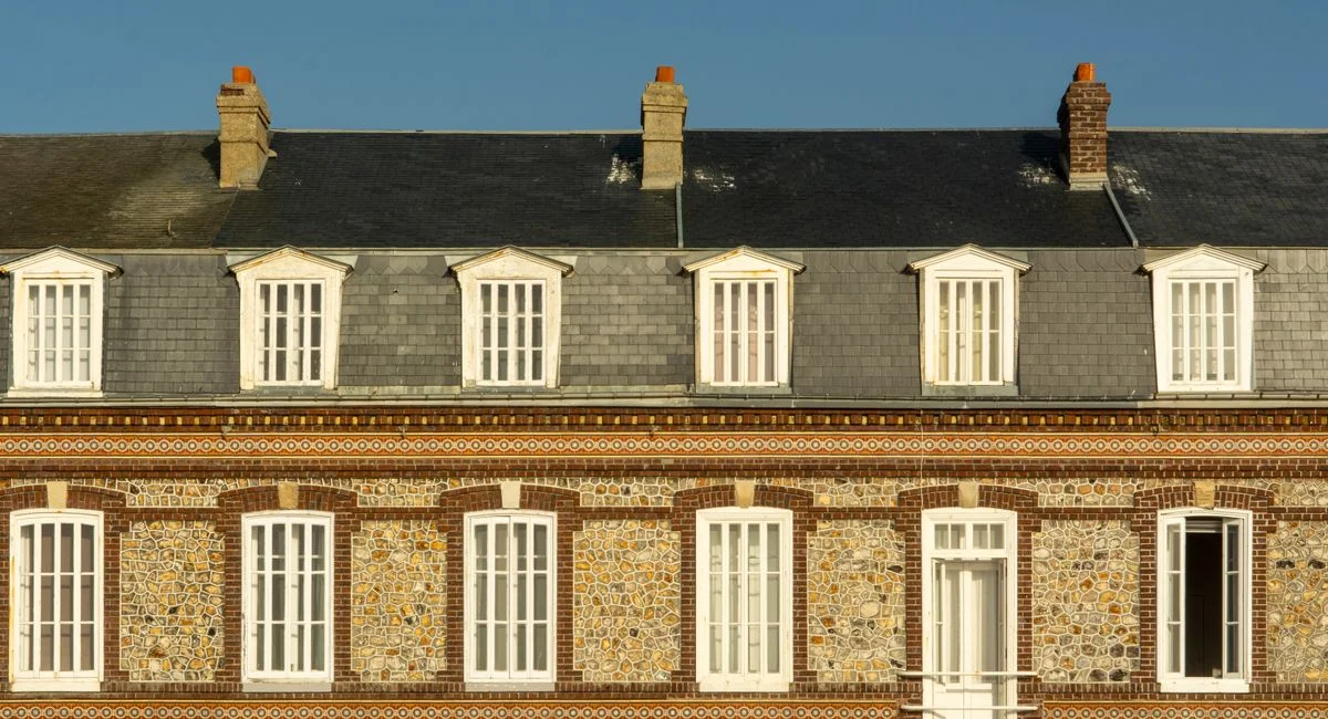 Explore the intricate architecture of a traditional house facade in Fécamp, Normandy.
