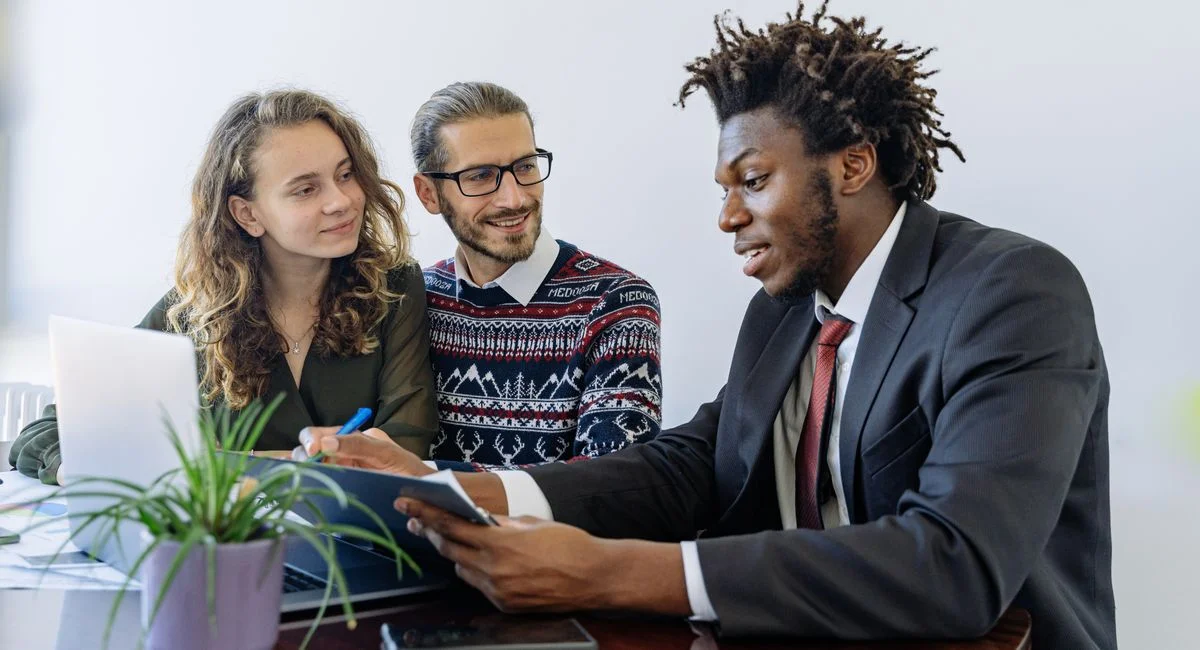 A diverse group of professionals collaborating in an office meeting, showcasing teamwork and partnership.